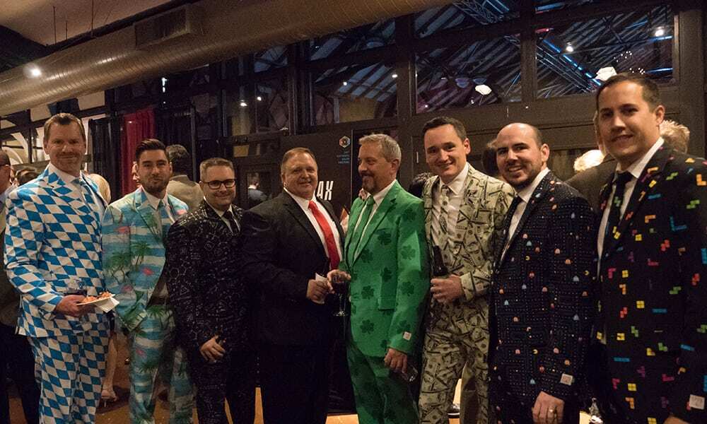The San Diego sales staff dressed in full-print suits during Casino Night at the National Sales Meeting. The suits had patterns of money, Pac Man, a Hawaiian-theme, and math equations.