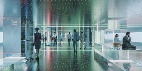 People dressed in business professional attire walking around a modern, technologically advanced office.