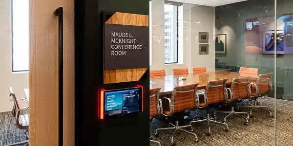 wide shot of a modern boardroom including the boardroom control panel on the wall