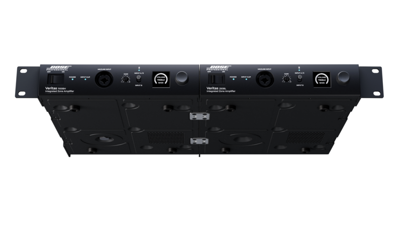 Bottom view of two black Bose Professional Veritas integrated zone amplifiers mounted side by side, showing the underside panels, ventilation grilles, mounting hardware, and front control layouts against a dark background.
