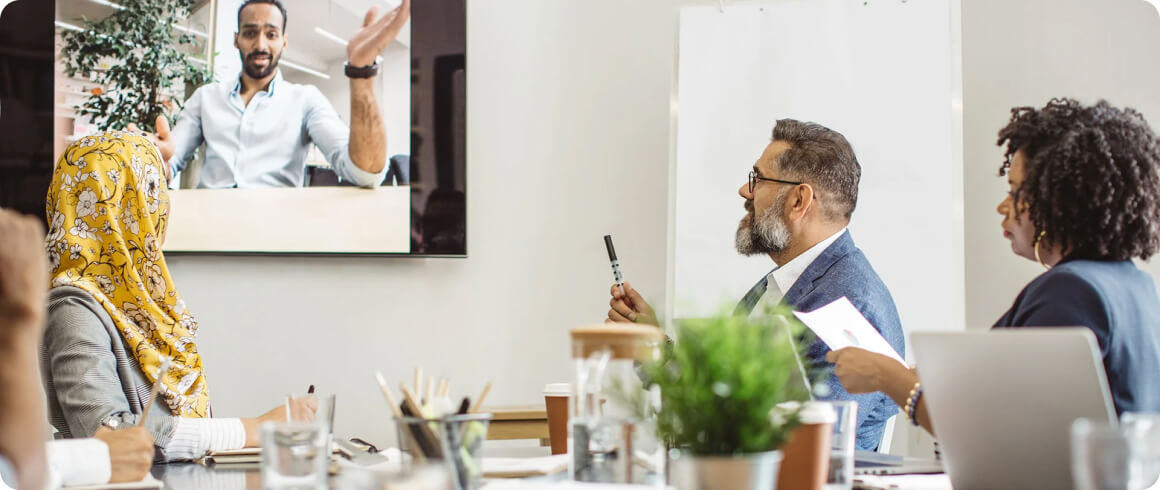 Government workers on video call in meeting room