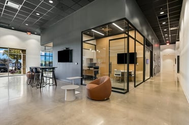 Modern workspace inside FORTÉ’s Austin office with glass meeting rooms