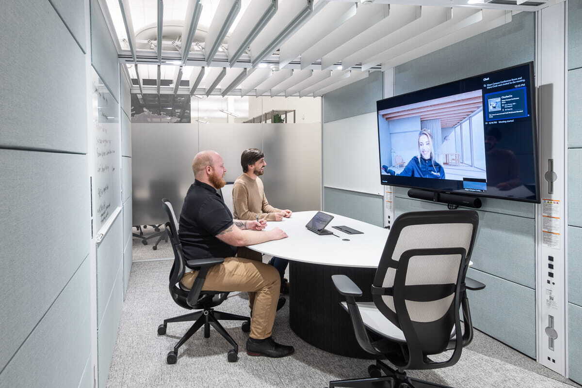 Coworkers on video call in Microsoft Teams Room